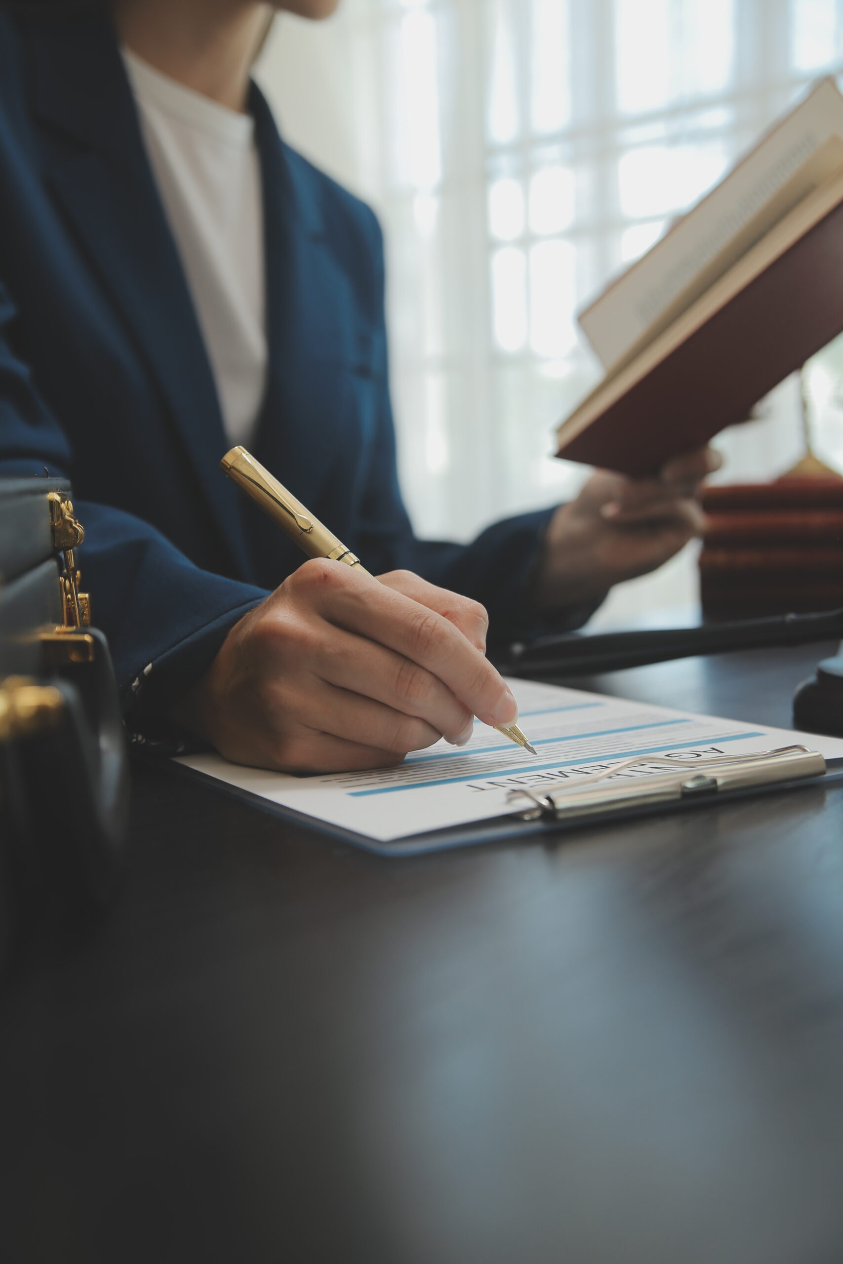 lawyer working with contract papers and wooden gavel on tab
